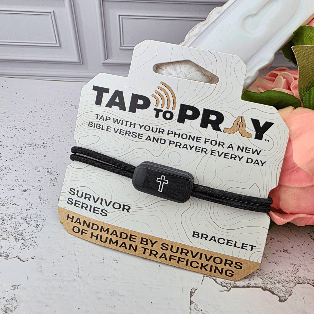 A black elastic bracelet with a black cross charm, 'TAP TO PRAY' and 'SURVIVOR SERIES BRACELET', Sister Dulce Gift Shop, Shepherds Staff, Religious Store, Cypress Springs Mercedarian Prayer Center, Catholic, new item, gift for men, confirmation