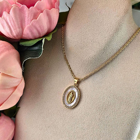 holy mother mary necklace gold and mother of pearl background