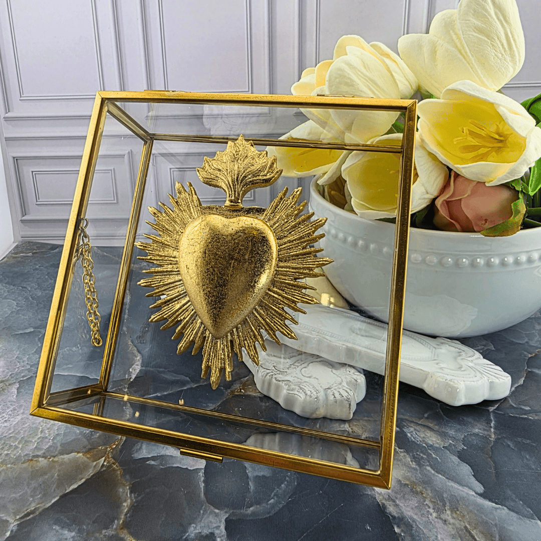 A gold Sacred Heart of Jesus decorative piece inside a clear glass display case with a gold frame, Sister Dulce Gift Shop, Shepherds Staff, Religious Store, Cypress Springs Mercedarian Prayer Center, Catholic, 