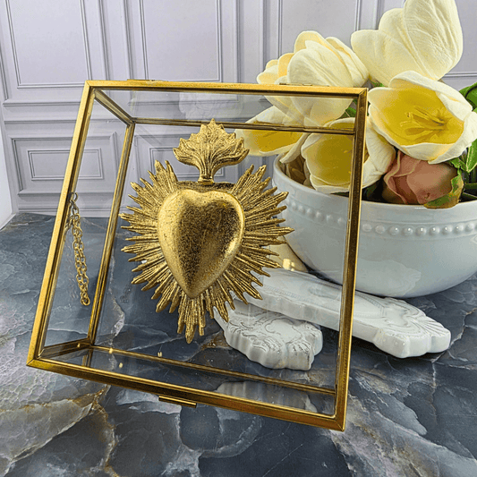 A gold Sacred Heart of Jesus decorative piece inside a clear glass display case with a gold frame, Sister Dulce Gift Shop, Shepherds Staff, Religious Store, Cypress Springs Mercedarian Prayer Center, Catholic, 