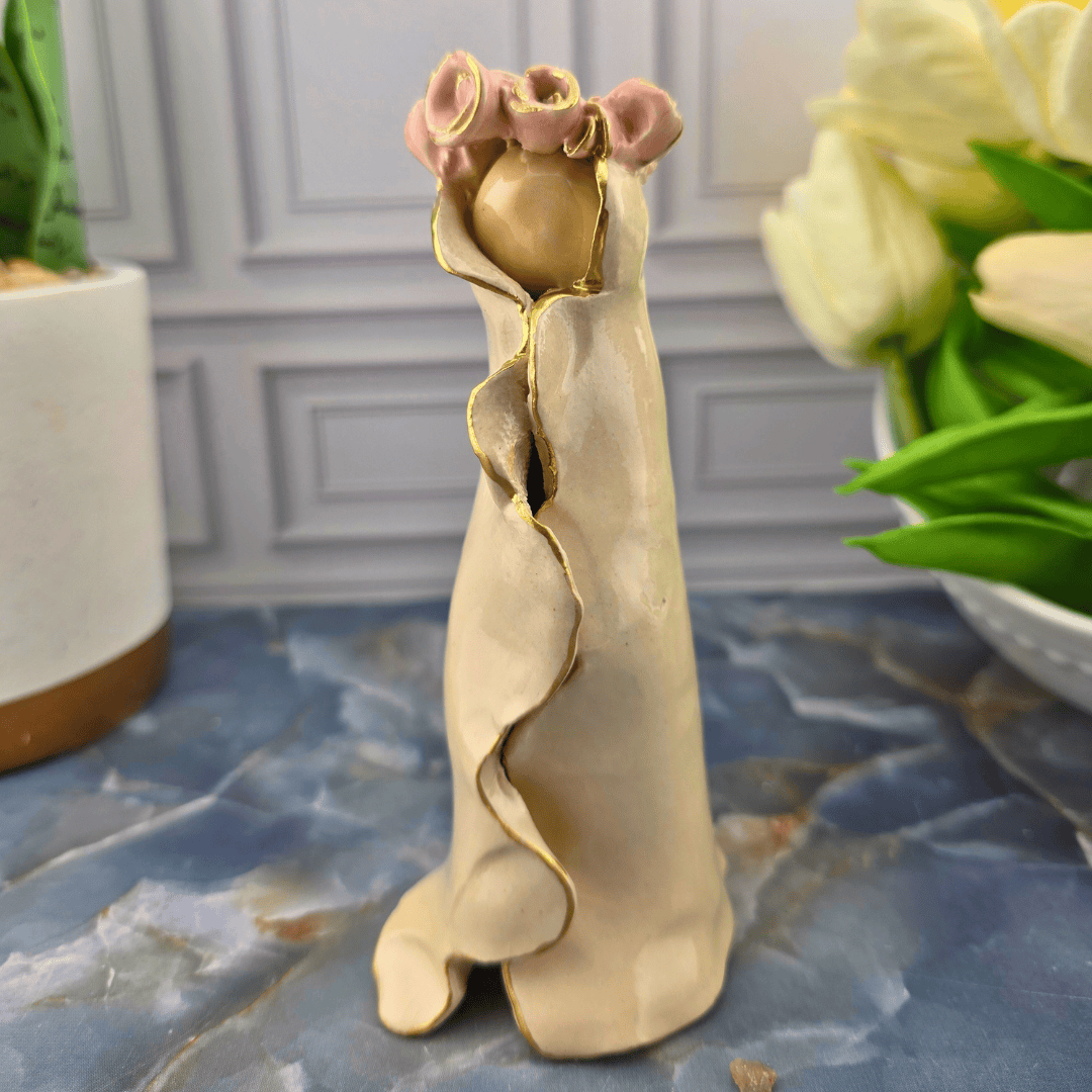 cream our lady with pink roses, A small decorative figurine of Mary in a flowing beige dress with gold trim and pink roses at the top, Sister Dulce Gift Shop, Shepherds Staff, Religious Store, Cypress Springs Mercedarian Prayer Center, Catholic, 