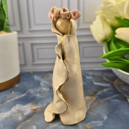 cream our lady with pink roses, A small decorative figurine of Mary in a flowing beige dress with gold trim and pink roses at the top, Sister Dulce Gift Shop, Shepherds Staff, Religious Store, Cypress Springs Mercedarian Prayer Center, Catholic, 