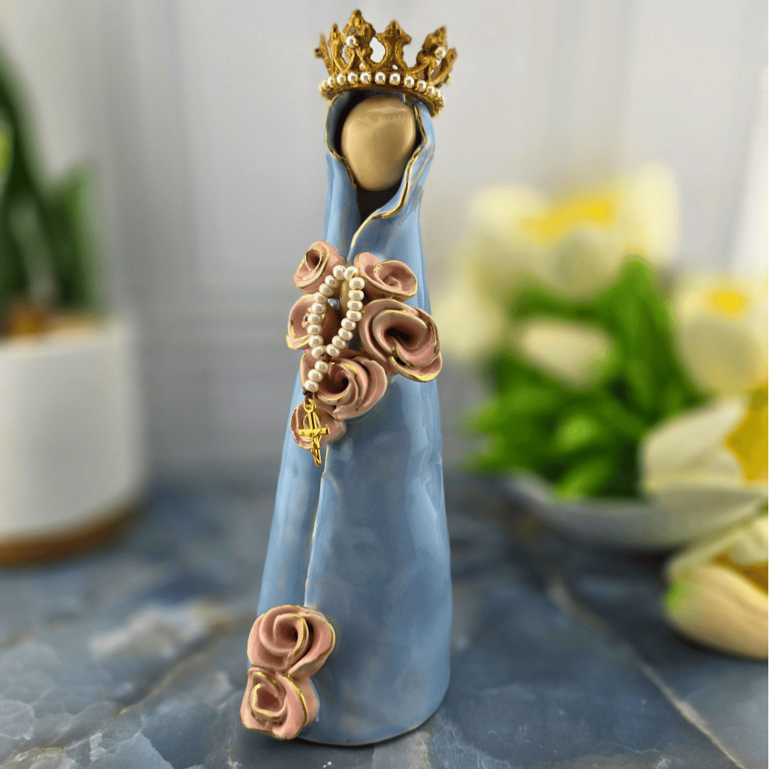Heavenly Mother, A decorative figurine of the Virgin Mary draped in a light blue cloak, adorned with pink rose details, a pearl rosary, and a gold crown, Sister Dulce Gift Shop, Shepherds Staff, Religious Store, Cypress Springs Mercedarian Prayer Center, Catholic, 