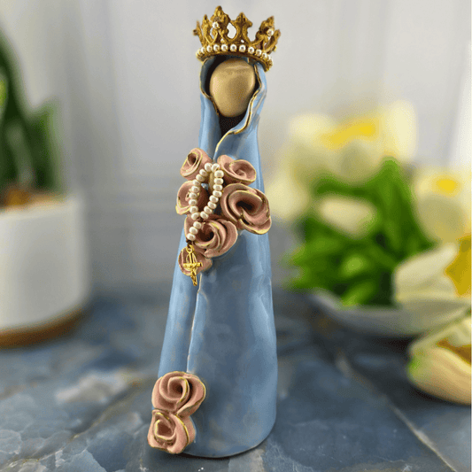 Heavenly Mother, A decorative figurine of the Virgin Mary draped in a light blue cloak, adorned with pink rose details, a pearl rosary, and a gold crown, Sister Dulce Gift Shop, Shepherds Staff, Religious Store, Cypress Springs Mercedarian Prayer Center, Catholic, 