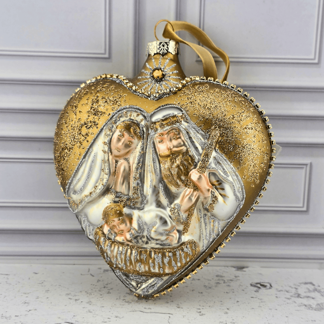 A heart-shaped gold and silver Christmas ornament featuring a detailed nativity scene with Mary, Joseph, and baby Jesus, complete with a gold hanging ribbon, Sister Dulce Gift Shop, Shepherds Staff, Religious Store, Cypress Springs Mercedarian Prayer Center, Catholic, christmas, new item, ornament,