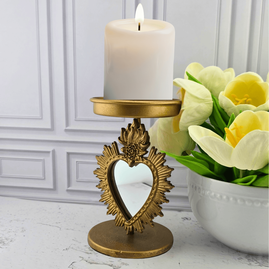 A gold-toned decorative candle holder with a heart-shaped mirror, mirrored heart candle holder, Sister Dulce Gift Shop, Shepherds Staff, Religious Store, Cypress Springs Mercedarian Prayer Center, Catholic, home decor