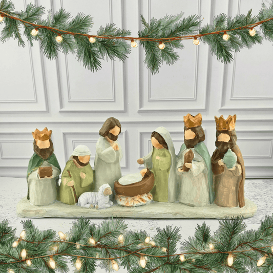 A painted wooden-style Nativity scene figurine set, featuring Mary, Joseph, baby Jesus in a manger, three wise men, and a small white sheep, Sister Dulce Gift Shop, Shepherds Staff, Religious Store, Cypress Springs Mercedarian Prayer Center, Catholic, christmas decor