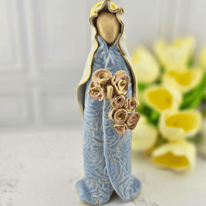 A ceramic figurine of the Virgin Mary wearing a light blue robe with gold trim and holding a bouquet of pink roses, Sister Dulce Gift Shop, Shepherds Staff, Religious Store, Cypress Springs Mercedarian Prayer Center, Catholic, new item, popular item, home decor, sacred treasures