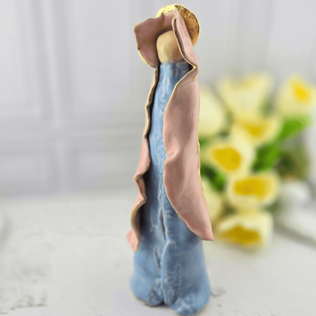 A ceramic angel figurine with a light blue robe, pink cloak, gold halo, our lady, mary, Sister Dulce Gift Shop, Shepherds Staff, Religious Store, Cypress Springs Mercedarian Prayer Center, Catholic, new item, popular item, sacred treasures, home decor