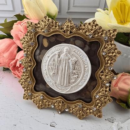 An ornate gold-toned decorative frame holding a circular white st. benedict medallion, Sister Dulce Gift Shop, Shepherds Staff, Religious Store, Cypress Springs Mercedarian Prayer Center, Catholic, new item, popular item, home decor, gift for her, young adult 